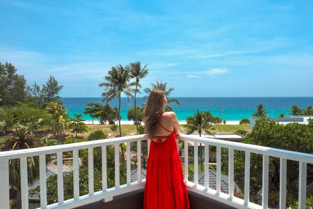 Woman on her seaview terrace at Thavorn Palm Beach, a MICE hotel in Phuket