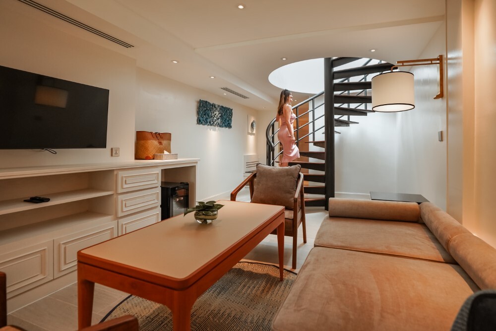 Luxurious sitting area in a guest room at Thavorn Palm Beach, a MICE hotel in Phuket