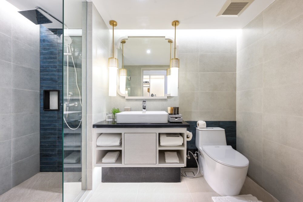 Modern ensuite bathroom with rain shower at Thavorn Palm Beach, a MICE hotel in Phuket