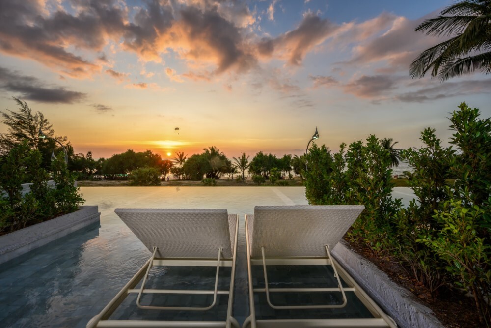 Infinity pool at sunset at Thavorn Palm Beach, a MICE hotel in Phuket