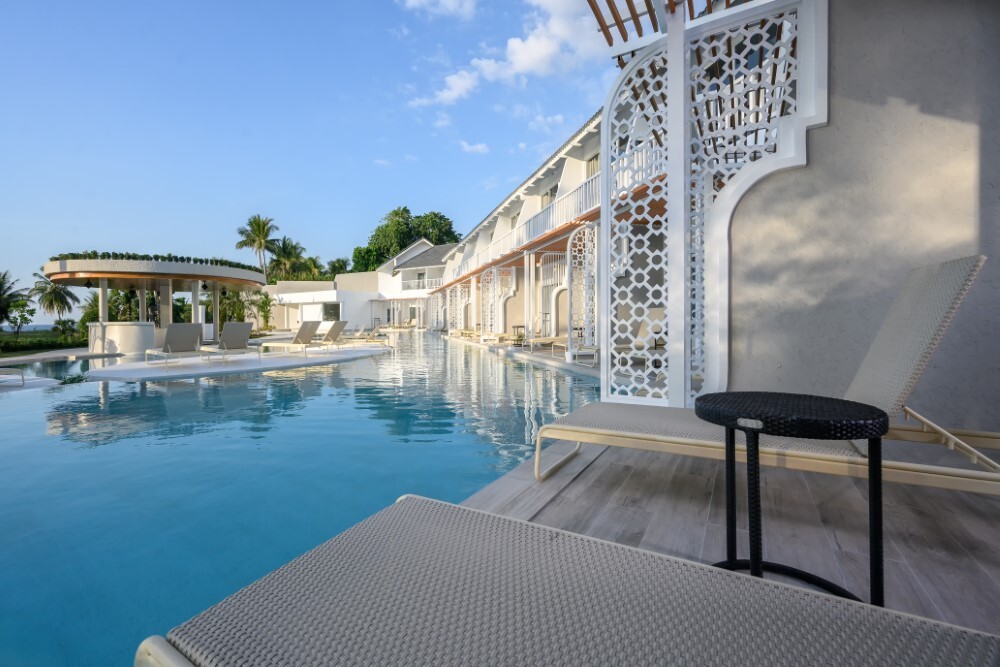 Lagoon pool room balcony with comfortable seating at Thavorn Palm Beach, a MICE hotel in Phuket